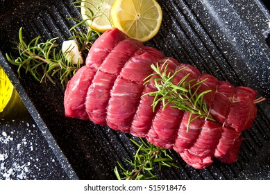 Roast Of Beef With Rosemary On Plate Pot On Black