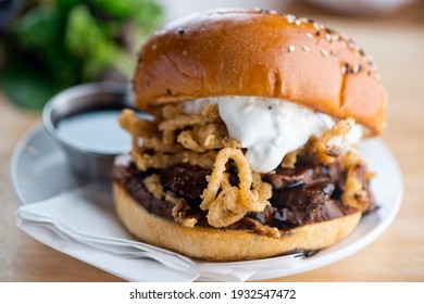 Roast Beef Sandwich. Classic Traditional American Diner sandwich. Thinly sliced roast beef topped with melted swiss cheese on top of a toasted hero roll with lettuce tomato and onion.  - Powered by Shutterstock