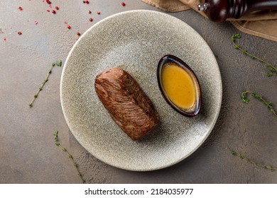 Roast Beef Steak With Honey Mustard Sauce On Plate On Brown Table