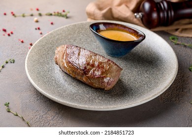 Roast Beef Steak With Honey Mustard Sauce On Plate On Brown Table