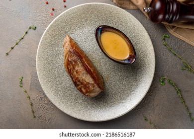 Roast Beef Steak With Honey Mustard Sauce On Plate On Brown Table