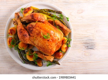 Roast chicken with asparagus and potato, served on plate