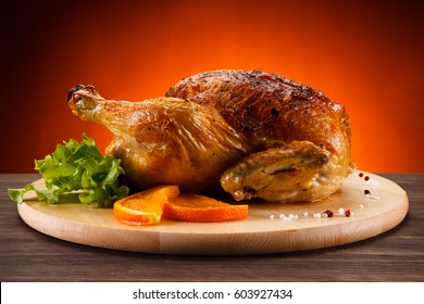 Roast chicken on cutting board 