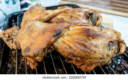 Roast chicken pieces fresh from the oven, resting on a rack to drain the excess fat. Home cooked. Close-up view. Catering concept for all kinds of social gathering. - Shutterstock ID 2202845759