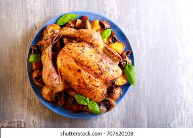 Roast Chicken With Potato And Mushrooms On Plate