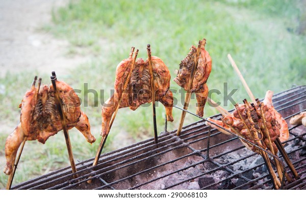 Roast chicken\
shop dividing the wayside in thailand,hot roasting chicken on\
smoked grill barbecue, thai local\
food