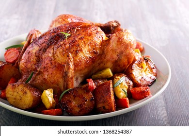 Roast chicken with vegetables on plate