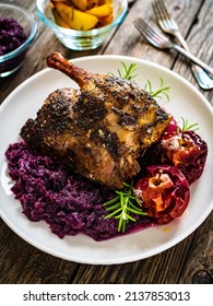 Roast Duck Thigh With Fruits And And Red Cabbage On Wooden Table