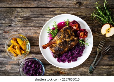 Roast Duck Thigh With Fruits And And Red Cabbage On Wooden Table