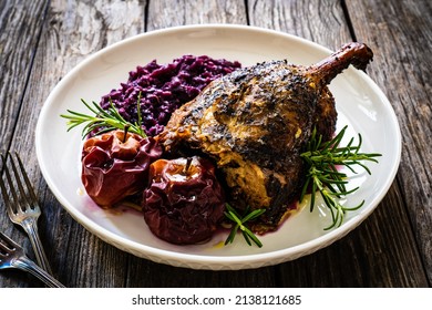 Roast Duck Thigh With Fruits And And Red Cabbage On Wooden Table