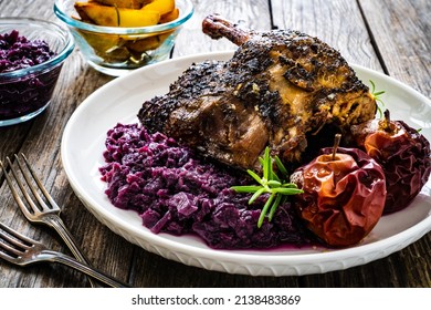 Roast Duck Thigh With Fruits And And Red Cabbage On Wooden Table