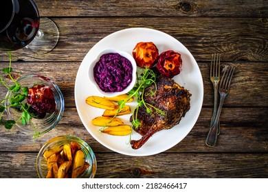 Roast Duck Thigh With, Baked Potatoes, Fruits And And Red Cabbage On Wooden Table 