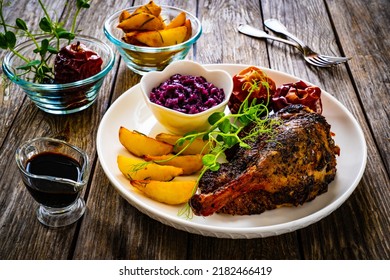 Roast Duck Thigh With, Baked Potatoes, Fruits And And Red Cabbage On Wooden Table 