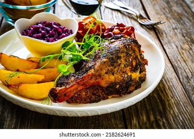 Roast Duck Thigh With, Baked Potatoes, Fruits And And Red Cabbage On Wooden Table 