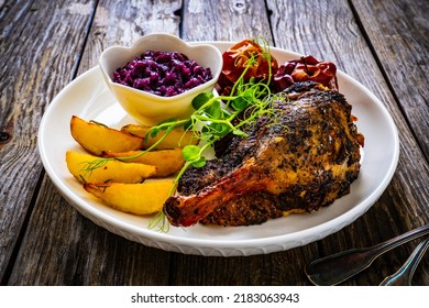 Roast Duck Thigh With, Baked Potatoes, Fruits And And Red Cabbage On Wooden Table 