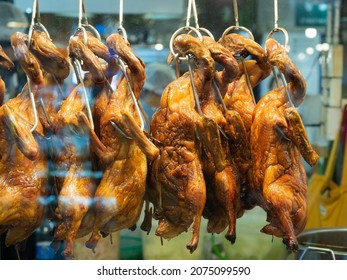 Roast Ducks Are Displayed In A Glass Cabinet In Front Of A Chinese Restaurant.