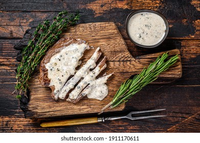 Roast Fillet Beef Meat Steak With Peppercorn Sauce On Wooden Board. Dark Wooden Background. Top View