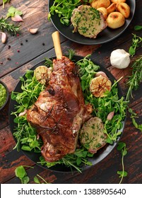 Roast Lamb Leg With Mint Sauce, Rosemary And Garlic. On Black Plate, Wooden Table