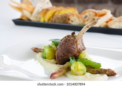 Roast Lamb In A Pistachio Crust Of Bronte With Brussel Sprouts And Asparagus