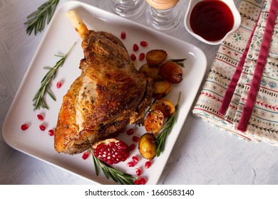 Roast Leg Of Lamb With Potatoes, Pomegranate And Rosemary. View From Above, Top View