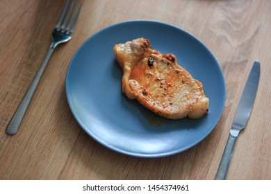 roast meat on a blue plate that stands on the table