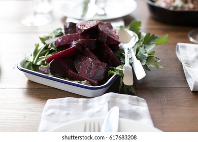 Roast Organic Beetroot With Salad On Set Dinner Table