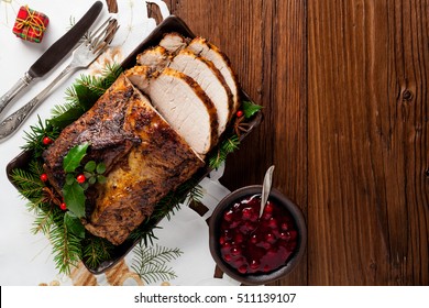 Roast Pork Loin With Christmas Decoration. Top View. Wooden Background.  