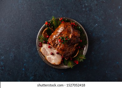 Roast Pork Neck In Christmas Style. Dark Navy Blue Background. Christmas Accessories. Top View.