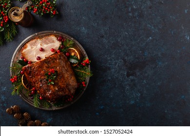 Roast Pork Neck In Christmas Style. Dark Navy Blue Background. Christmas Accessories. Top View.