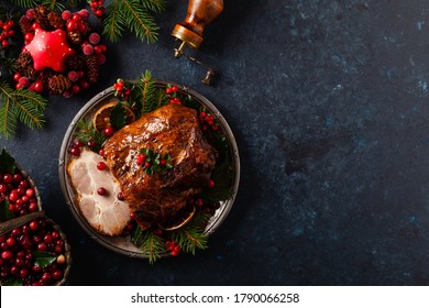 Roast Pork Neck In Christmas Style. Dark Navy Blue Background. Christmas Accessories. Top View.