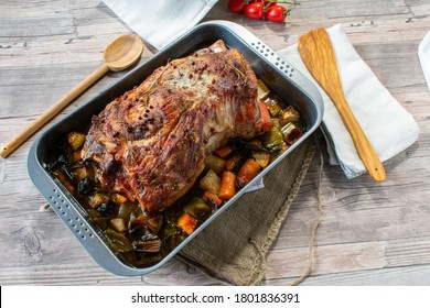 Roast Pork With Root Vegetables In A Baking Pan From Above