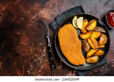 Roast pork schnitzel with fried potato, cooked meat steak. Dark background. Top view. Copy space - Powered by Shutterstock