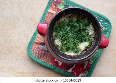 Roast In A Pot With Cheese And Herbs On A Wooden Background On A Christmas Pot, Top View