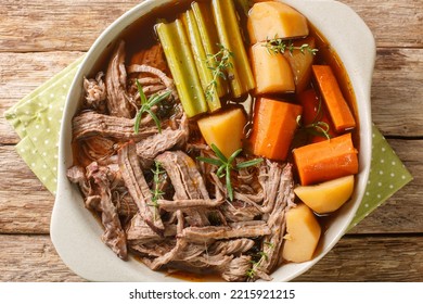 Roast Pot Of Slow Cooked Beef With Vegetables In A Spicy Sauce Close-up In A Frying Pan On The Table. Horizontal Top View From Above
