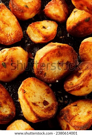 Roast potatoes on frying pan background