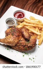Roast Rotisserie Half Chicken With French Fries Simple Meal On Wood Table