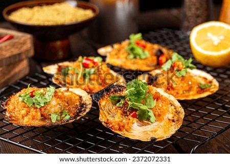 Roast scallops on a charcoal stove Asian style roast scallops