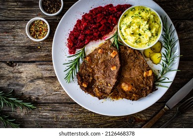 Roast Stuffed Beef With Potato Puree And Red Beets On Wooden Table 