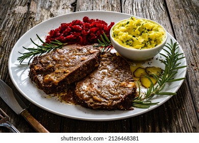 Roast Stuffed Beef With Potato Puree And Red Beets On Wooden Table 