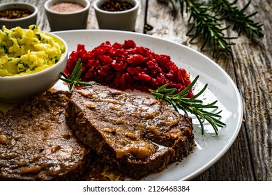 Roast Stuffed Beef With Potato Puree And Red Beets On Wooden Table 