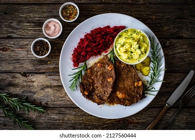 Roast Stuffed Beef With Potato Puree And Red Beets On Wooden Table 