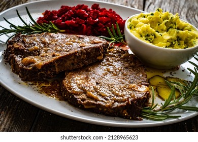 Roast Stuffed Beef With Potato Puree And Red Beets On Wooden Table 