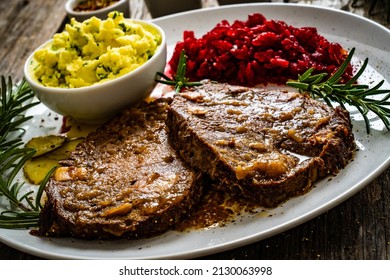 Roast Stuffed Beef With Potato Puree And Red Beets On Wooden Table 