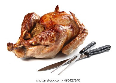 Roast Turkey With Carving Fork And Knife, Isolated On White Background, Shallow Focus