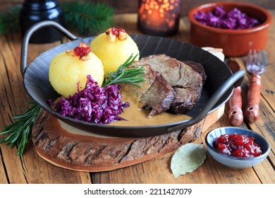 roast wild boar with dumplings - Shutterstock ID 2211427079