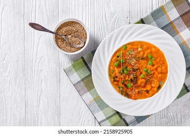 Roast Yams And Carrot Soup With Green Peas And Vegetables In White Bowl On White Wood Table With Herbs, Sesame And Pumpkin Seeds, Horizontal View From Above, Flat Lay, Free Space