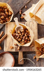Roasted almonds with cinnamon in little paper bags