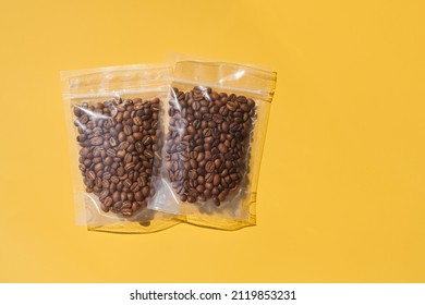 Roasted arabica beans in blank transparent plastic bag with zipper on yellow background. Specialty and alternative sample coffee trendy concept. Space for text, mock up, top view, flat lay, isolated - Shutterstock ID 2119853231