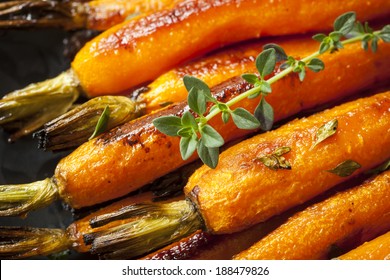 Roasted Baby Carrots Garnished With Thyme.