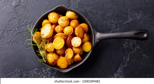 Roasted Baby Potatoes In Iron Skillet. Dark Grey Background. Top View.